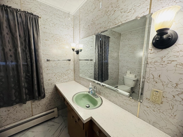 bathroom with baseboard heating, vanity, and toilet