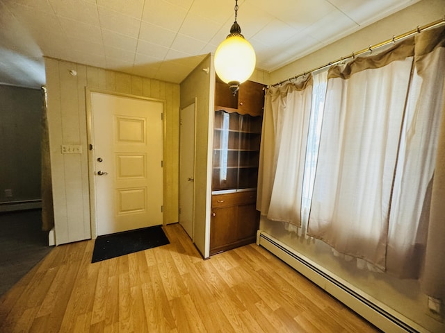 entrance foyer with baseboard heating and light wood-type flooring