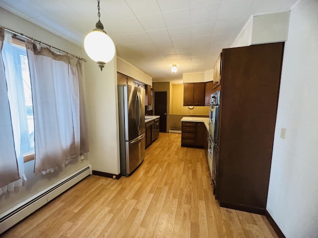 kitchen featuring appliances with stainless steel finishes, a baseboard radiator, dark brown cabinets, and hanging light fixtures