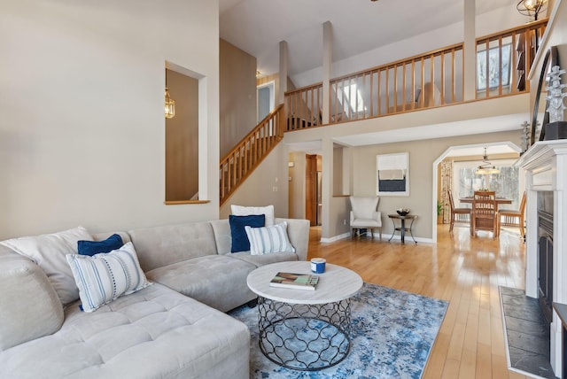 living room with a high ceiling and hardwood / wood-style floors