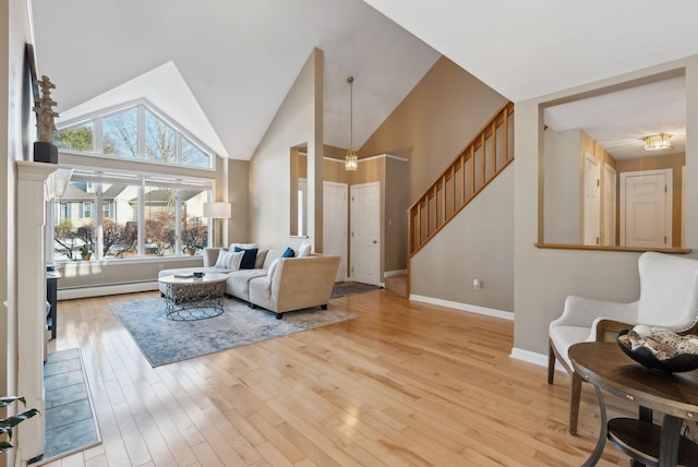 living room featuring light wood-type flooring and a baseboard heating unit