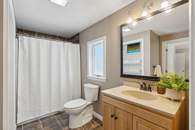 bathroom with toilet, tile patterned floors, and vanity