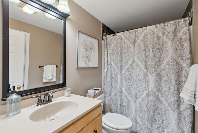 bathroom with vanity and toilet