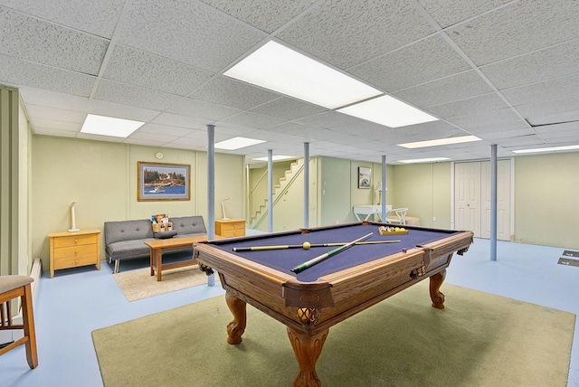 recreation room featuring a paneled ceiling, concrete floors, and billiards