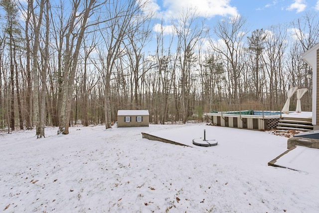 snowy yard with a storage unit