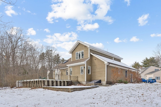 view of snow covered rear of property