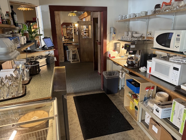 63 Main St, Bucksport, ME 04416 - kitchen with white microwave and carpet flooring