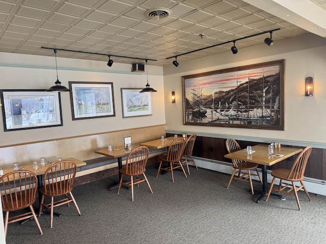 63 Main St, Bucksport, ME 04416 - carpeted dining room featuring rail lighting and a wainscoted wall