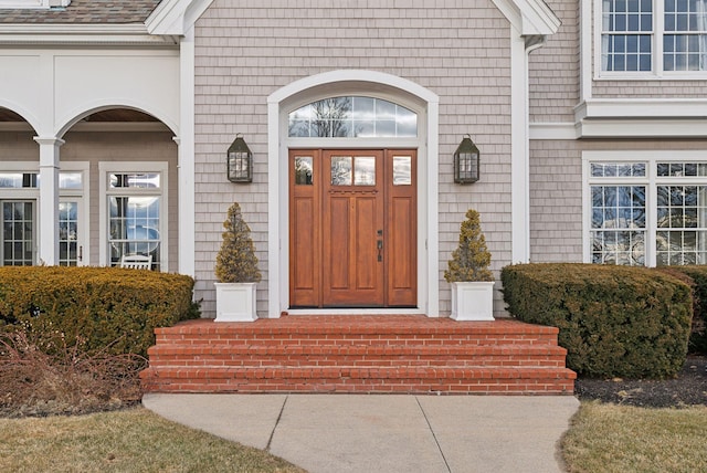 property entrance with roof with shingles