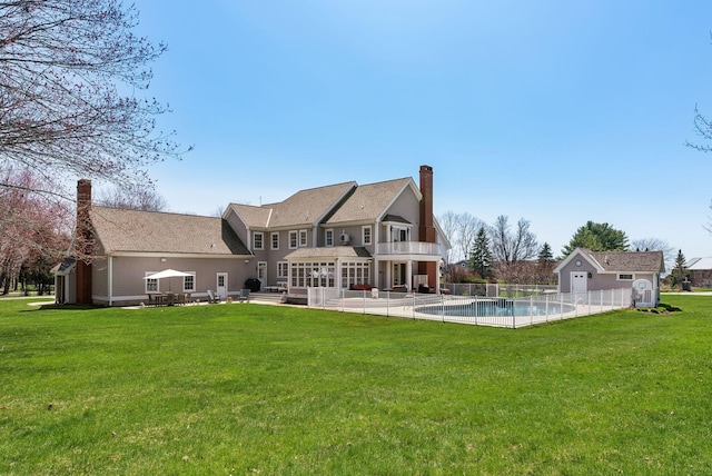 6 Ebb Tide Dr, Cumberland, ME 04110 - back of property with fence, a fenced in pool, a chimney, a lawn, and a patio
