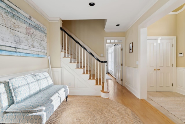 6 Ebb Tide Dr, Cumberland, ME 04110 - entrance foyer featuring ornamental molding, a decorative wall, light wood-type flooring, and stairs