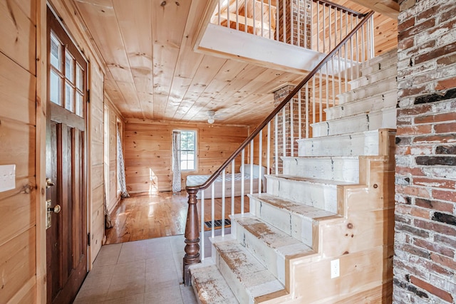 entrance foyer featuring wood walls and wood ceiling