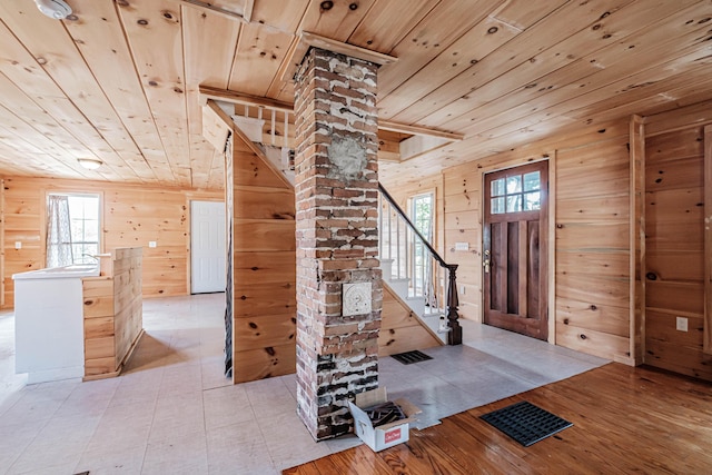 entryway featuring wooden walls, plenty of natural light, and wooden ceiling