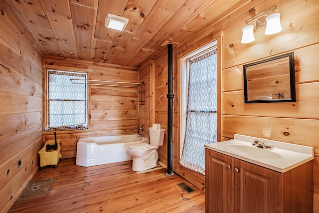 bathroom featuring vanity, wood-type flooring, wooden ceiling, toilet, and a bathing tub