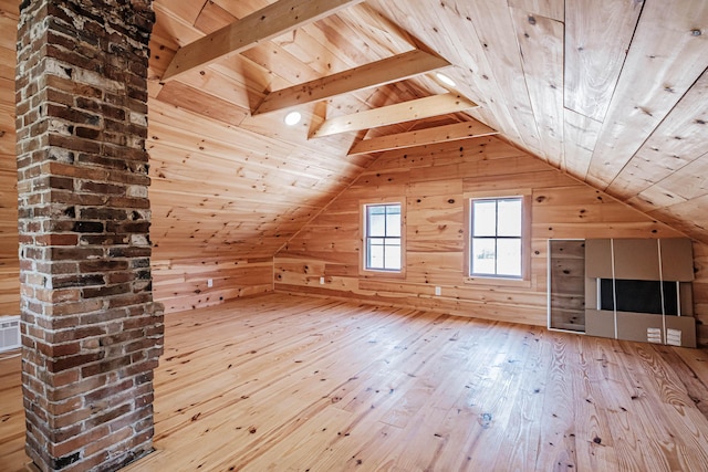 additional living space featuring vaulted ceiling, light hardwood / wood-style flooring, wood walls, and wood ceiling