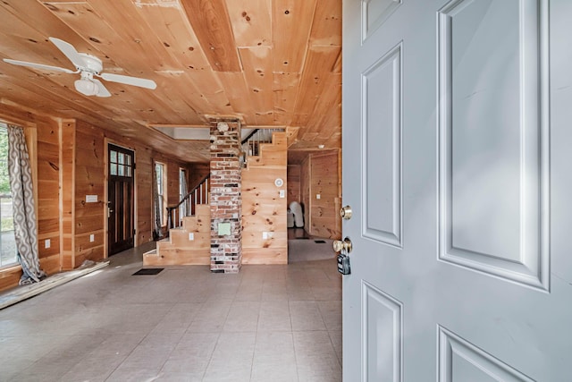 foyer with wooden walls, ceiling fan, and wood ceiling