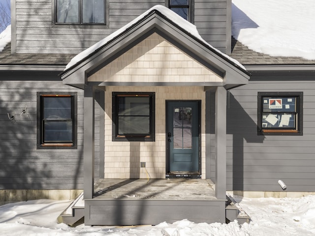 view of snow covered property entrance