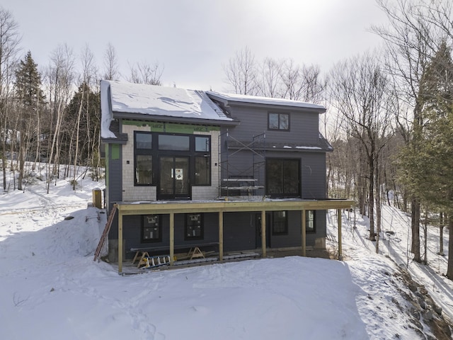 snow covered property with french doors