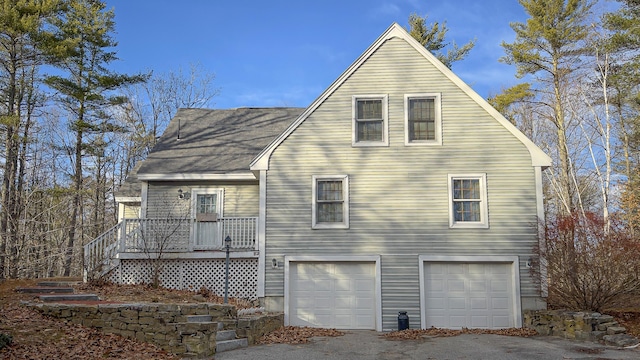 22 Jewett Rd, Raymond, ME 04071 - rear view of house featuring an attached garage and a shingled roof
