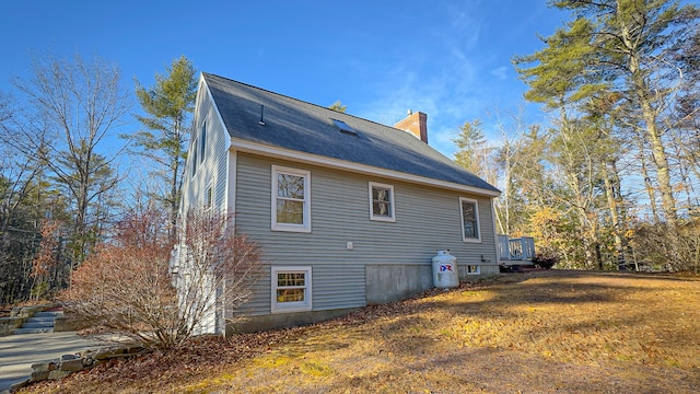 22 Jewett Rd, Raymond, ME 04071 - back of house featuring a yard and a chimney