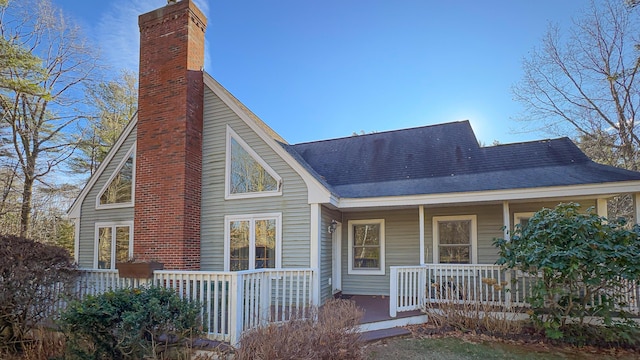 22 Jewett Rd, Raymond, ME 04071 - back of property featuring a porch, a chimney, and a shingled roof