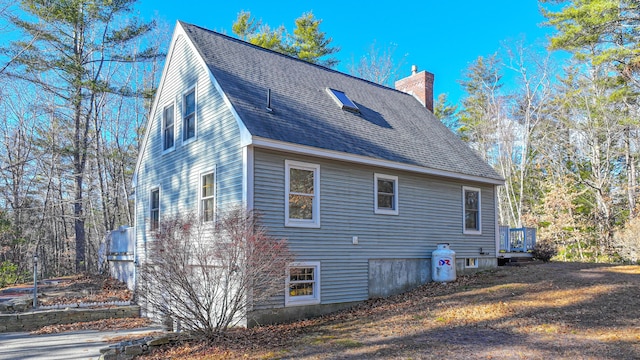 22 Jewett Rd, Raymond, ME 04071 - view of side of home with roof with shingles and a chimney