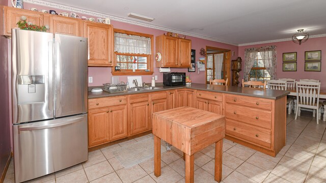 22 Jewett Rd, Raymond, ME 04071 - kitchen with stainless steel fridge, dark countertops, a peninsula, crown molding, and light tile patterned flooring