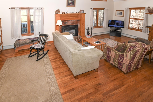 22 Jewett Rd, Raymond, ME 04071 - living room with plenty of natural light, wood finished floors, and a fireplace
