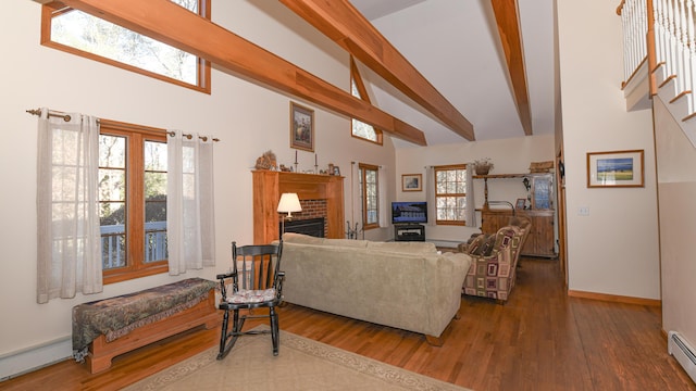 22 Jewett Rd, Raymond, ME 04071 - living area with baseboard heating, a brick fireplace, beam ceiling, a baseboard radiator, and wood finished floors