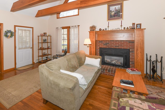 22 Jewett Rd, Raymond, ME 04071 - living room featuring wood finished floors, a baseboard heating unit, a brick fireplace, and beam ceiling