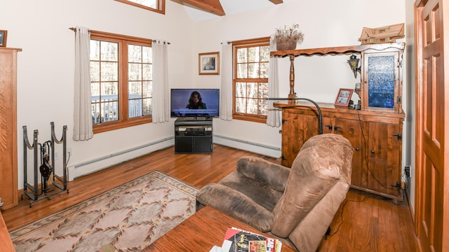 22 Jewett Rd, Raymond, ME 04071 - living room with baseboard heating, a baseboard radiator, wood finished floors, and lofted ceiling
