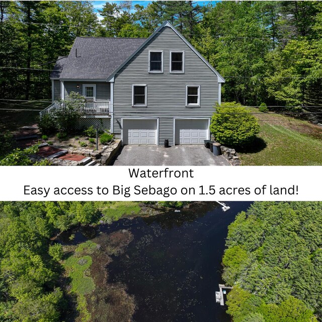 22 Jewett Rd, Raymond, ME 04071 - view of front facade featuring a garage, asphalt driveway, a deck, and roof with shingles