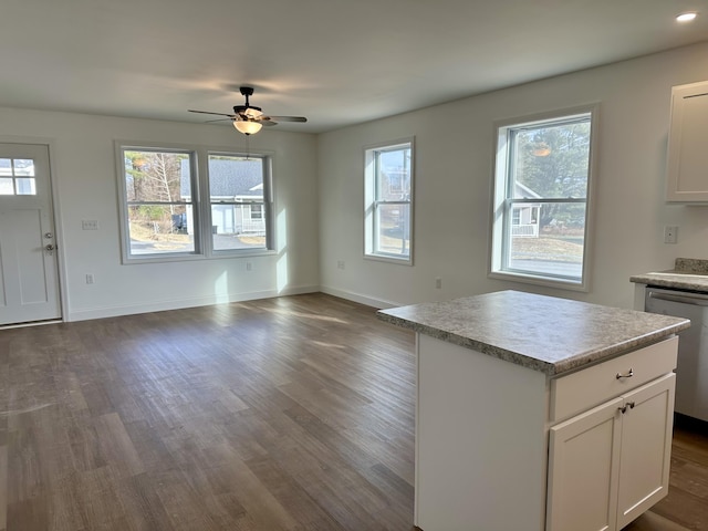 kitchen featuring dishwasher, white cabinetry, ceiling fan, and a kitchen island