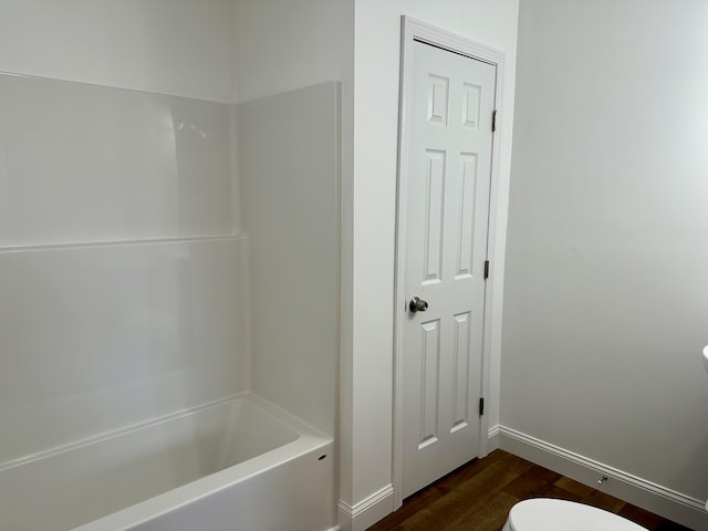 bathroom featuring hardwood / wood-style floors and toilet