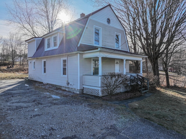 view of side of home with a porch