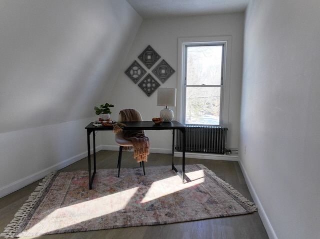 office space with lofted ceiling, dark wood-type flooring, and radiator