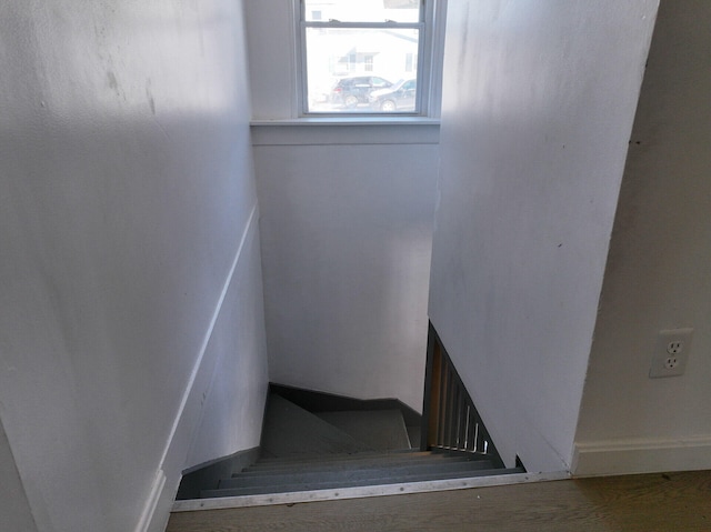 staircase featuring a fireplace