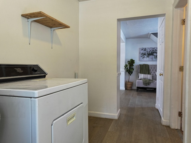 clothes washing area featuring dark hardwood / wood-style floors, a textured ceiling, and washer / clothes dryer