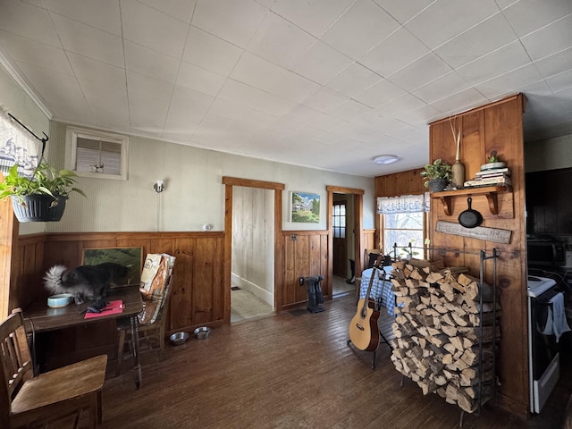 living room with dark hardwood / wood-style floors and wood walls