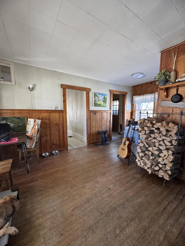 living room with dark hardwood / wood-style floors and wooden walls