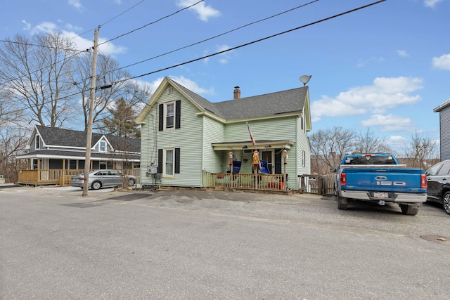 view of property featuring covered porch