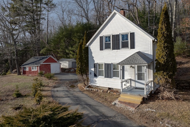 view of front of property with a garage and an outdoor structure