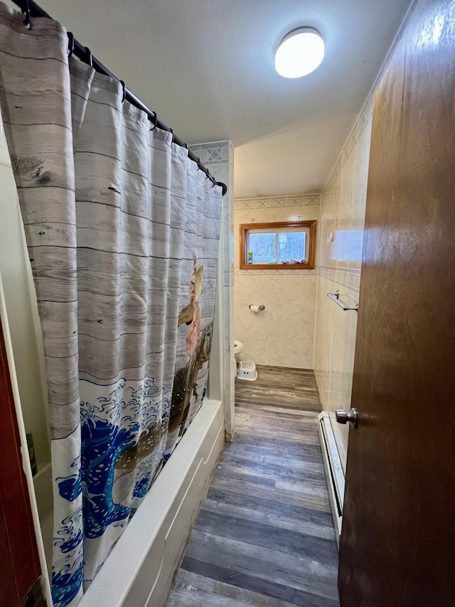 bathroom featuring hardwood / wood-style floors, toilet, and baseboard heating