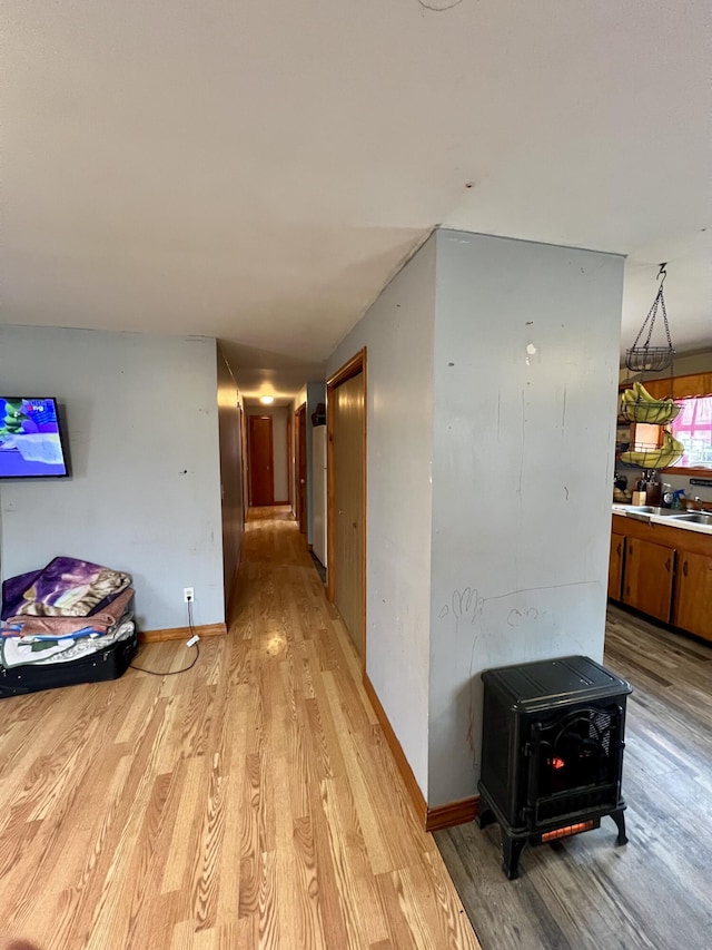 hallway with light hardwood / wood-style flooring and sink