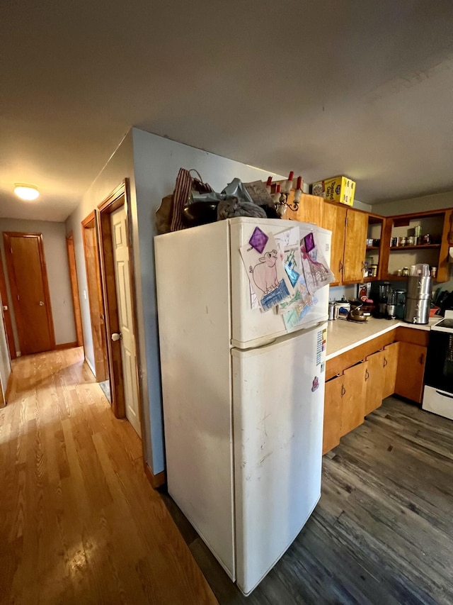 kitchen with dark wood-type flooring and white appliances