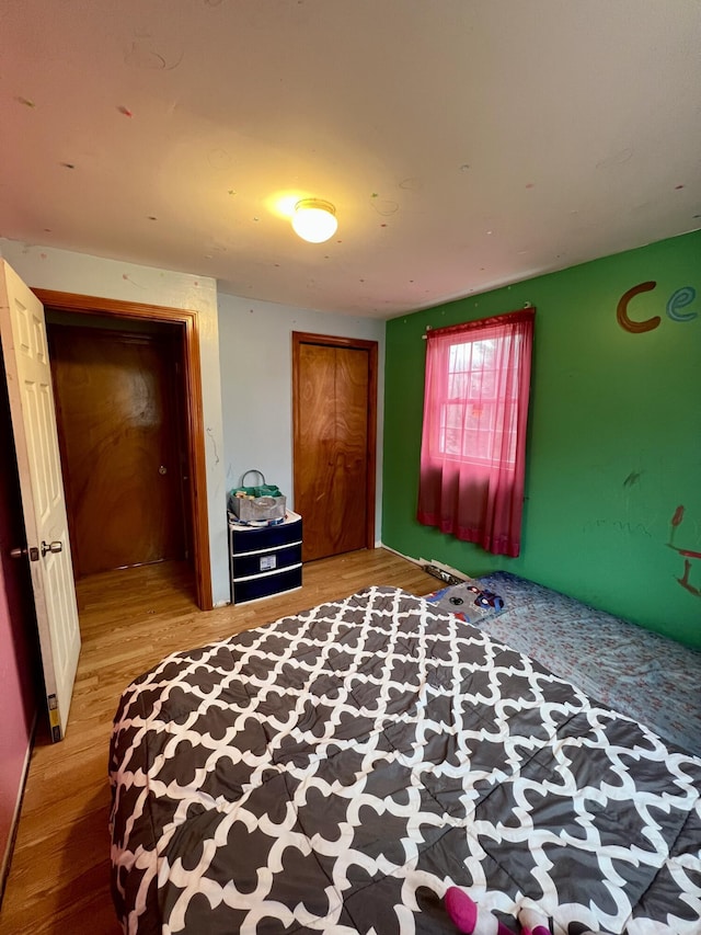 unfurnished bedroom featuring wood-type flooring and a closet