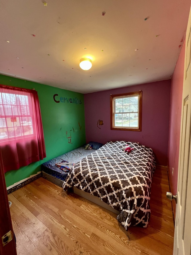 bedroom with wood-type flooring