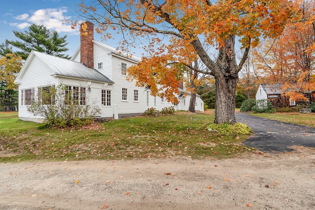 view of property exterior with a lawn