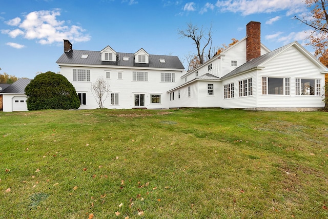 rear view of property with a lawn