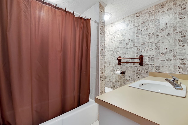 bathroom with shower / tub combo, vanity, and a textured ceiling